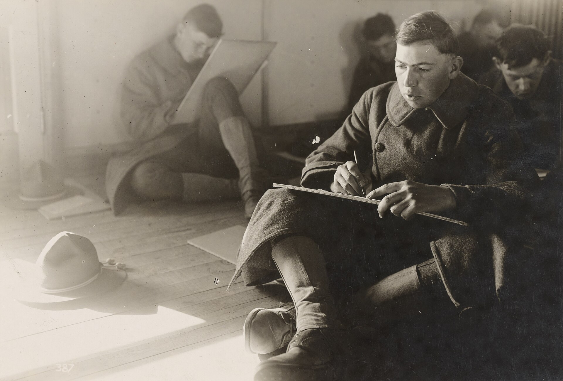 Rows of American soldiers seated at desks taking a written group mental test in 1917, an early mass aptitude examination.