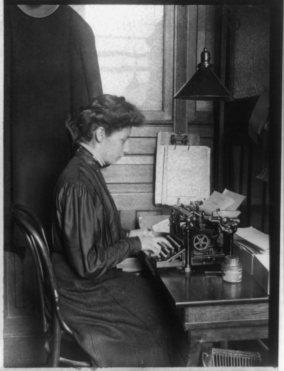 A young woman at a typewriter.